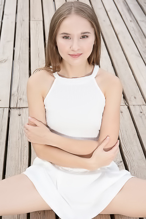 Sasha Quinn Smiling Playfully As Her Short Skirt Flips Up To Reveal She’s Not Wearing Panties