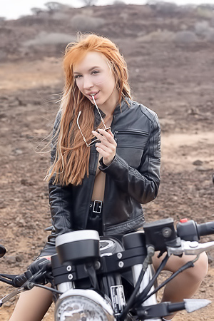 Lilly Mays Rides A Motorcycle In The Desert Wearing A Leather Jacket And Miniskirt