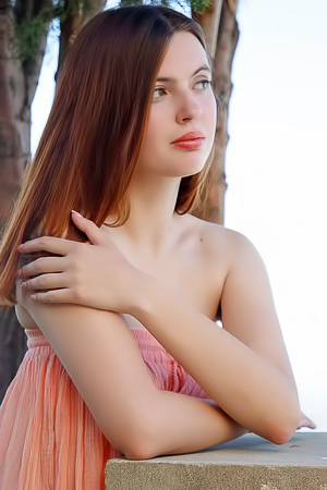 Felicia Vina Showcases Allure Sitting Nude By A Stone Pillar Amidst Trees
